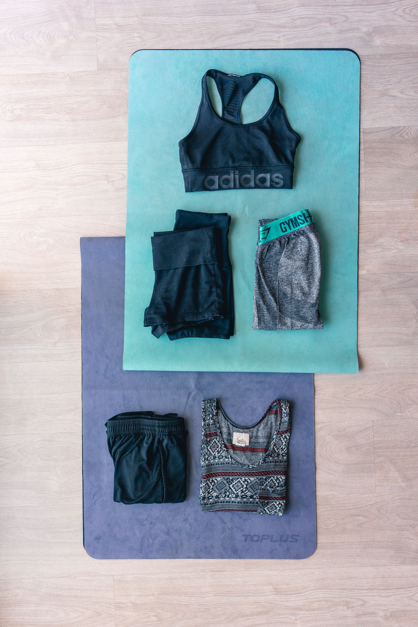 Training clothes arranged together in a clean flat lay — Gym Shorts and Joggers: Fabrics, Fit, and What to Wear for Each Session